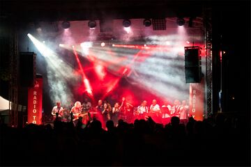 Live band on stage in front of an audience in the spotlight